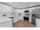 Bright kitchen with white cabinets, stainless appliances, and quartz countertops at 2214 Selkirk St, Valrico, FL 33594