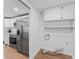 Adjacent laundry area with washer and dryer hookups next to kitchen with stainless fridge at 2214 Selkirk St, Valrico, FL 33594