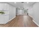 Bright open floorplan featuring white walls, wood-look floors, and contemporary ceiling fan at 2214 Selkirk St, Valrico, FL 33594