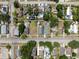 Overhead view of a residential neighborhood showcasing homes with mixed rooftops, landscaped yards, and a tranquil tree canopy at 2217 Stuart St, Tampa, FL 33605