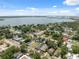 Neighborhood aerial view with lovely homes, mature trees, and a beautiful waterfront view under a bright blue sky at 2217 Stuart St, Tampa, FL 33605