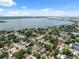 Tranquil neighborhood featuring diverse homes, lush greenery, and a serene waterfront backdrop under a blue, cloud-dotted sky at 2217 Stuart St, Tampa, FL 33605
