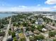 Picturesque neighborhood aerial with vibrant homes, mature trees, and a stunning waterfront backdrop under a clear sky at 2217 Stuart St, Tampa, FL 33605