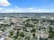 Expansive aerial view of the neighborhood with roads and commercial area, and clear blue sky at 2217 Stuart St, Tampa, FL 33605