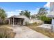 Spacious backyard featuring a carport, storage shed, and a quaint seating area for outdoor enjoyment at 2217 Stuart St, Tampa, FL 33605