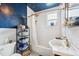 Charming bathroom with dark blue star mural on ceiling, tiled walls and floors, white bathtub and a unique pedestal sink at 2217 Stuart St, Tampa, FL 33605