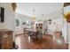 Bright dining room features hardwood floors, white walls, vintage Tiffany lamp, and an adjacent entryway to other parts of home at 2217 Stuart St, Tampa, FL 33605