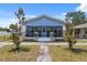 Charming single Gathering home featuring a screened-in front porch, blue siding, and mature trees at 2217 Stuart St, Tampa, FL 33605