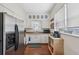 Bright kitchen featuring white cabinets, stainless steel refrigerator, and sink with a window for viewing the backyard at 2217 Stuart St, Tampa, FL 33605