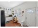 Charming kitchen with white cabinets, laminate wood floor, stainless appliances and view of backyard from kitchen door window at 2217 Stuart St, Tampa, FL 33605