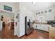 Kitchen featuring white walls and cabinets, stainless steel refrigerator and oven, and stainless steel sink with a window at 2217 Stuart St, Tampa, FL 33605