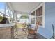 Charming screened-in porch featuring comfortable rocking chairs and views of the neighborhood at 2217 Stuart St, Tampa, FL 33605