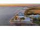 Aerial view of a charming waterfront home with lush greenery and access to the water at 2417 Sunset Vista Dr, Spring Hill, FL 34607
