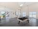Finished basement area with epoxy floors, ping pong, and pool table at 2417 Sunset Vista Dr, Spring Hill, FL 34607