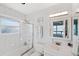 Bright bathroom with a shower/tub combo and vanity, offering a glimpse of the water view at 2417 Sunset Vista Dr, Spring Hill, FL 34607