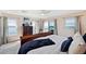 Bedroom features a water view, light carpet, neutral walls, and light-filled sliding glass door at 2417 Sunset Vista Dr, Spring Hill, FL 34607
