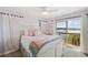 Comfortable bedroom featuring a sliding glass door with water views and a ceiling fan at 2417 Sunset Vista Dr, Spring Hill, FL 34607