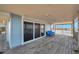 Covered outdoor patio featuring deck with blue seating and stunning water views at 2417 Sunset Vista Dr, Spring Hill, FL 34607