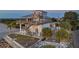 Waterfront home featuring a spiral staircase, multiple decks, and lush tropical landscaping at 2417 Sunset Vista Dr, Spring Hill, FL 34607