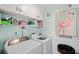 Practical laundry room with storage cabinets and washer/dryer units at 2417 Sunset Vista Dr, Spring Hill, FL 34607