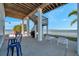 This beautiful patio features an outdoor shower, a grill, and a view of the bay at 2417 Sunset Vista Dr, Spring Hill, FL 34607