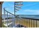Exterior spiral staircase featuring wooden deck and scenic water views at 2417 Sunset Vista Dr, Spring Hill, FL 34607