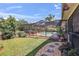 Beautiful backyard with a screened-in pool area, patio, and lush landscaping at 2428 Oak Landing Dr, Brandon, FL 33511