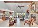 Bright living room showcasing a vaulted ceiling, exposed beams, and brick fireplace, with open layout to kitchen at 2428 Oak Landing Dr, Brandon, FL 33511