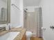 Bathroom with granite countertop, sink, toilet, mirror and walk-in shower at 2907 Mingo Dr, Land O Lakes, FL 34639