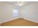A bright bedroom features wood floors, a window, and a closet at 2907 Mingo Dr, Land O Lakes, FL 34639