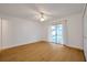 A bright bedroom features wood floors and sliding glass doors at 2907 Mingo Dr, Land O Lakes, FL 34639