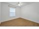 A bright bedroom features wood floors, a ceiling fan, and a window at 2907 Mingo Dr, Land O Lakes, FL 34639