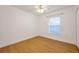 A bright bedroom features wood floors, a window, and a closet at 2907 Mingo Dr, Land O Lakes, FL 34639