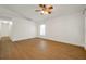 Bright bedroom featuring hardwood floors, ceiling fan, and ample natural light at 2907 Mingo Dr, Land O Lakes, FL 34639