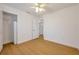 A bright bedroom features wood floors and a closet with shelving at 2907 Mingo Dr, Land O Lakes, FL 34639