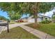 Exterior view of house number 2907 featuring a green lawn, mailbox and shade trees at 2907 Mingo Dr, Land O Lakes, FL 34639