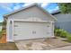 A well-maintained white garage door on a home at 2907 with black hardware at 2907 Mingo Dr, Land O Lakes, FL 34639