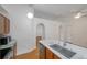 Bright kitchen features an island with a stainless sink and modern faucet at 2907 Mingo Dr, Land O Lakes, FL 34639