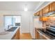 Bright kitchen features stainless appliances, updated countertop, wood cabinets, and mosaic backsplash at 2907 Mingo Dr, Land O Lakes, FL 34639
