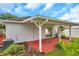 Back patio featuring white support beams and a sliding glass door leading to the backyard at 2907 Mingo Dr, Land O Lakes, FL 34639
