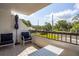 Spacious balcony with outdoor seating, overlooking a quiet residential street and verdant trees at 30 Turner St # 202, Clearwater, FL 33756
