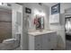 Bright bathroom features a white vanity, updated fixtures, and tile surround in the shower at 30 Turner St # 202, Clearwater, FL 33756