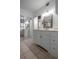Long bathroom with vanity, mirrors, tiled floors, and a doorway to another room at 30 Turner St # 202, Clearwater, FL 33756