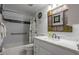 Bathroom with marble floors and shower-tub, featuring a single sink vanity at 30 Turner St # 202, Clearwater, FL 33756