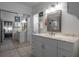 Bathroom with double sinks, white cabinets, a large mirror, and tile flooring at 30 Turner St # 202, Clearwater, FL 33756