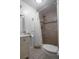 Bathroom features tiled shower with a rainfall showerhead and a white cabinet at 30 Turner St # 202, Clearwater, FL 33756