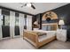 Comfortable bedroom with dark gray walls, a wooden bed, and a ceiling fan at 30 Turner St # 202, Clearwater, FL 33756