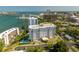 Aerial shot of a condominium complex with a pool, landscaping, and waterfront views at 30 Turner St # 202, Clearwater, FL 33756