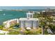 Overhead view of a condominium building with balconies, swimming pool, landscaping, and waterfront location at 30 Turner St # 202, Clearwater, FL 33756