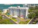Aerial view of a modern condominium building with balconies and well-maintained landscaping, near a waterfront at 30 Turner St # 202, Clearwater, FL 33756